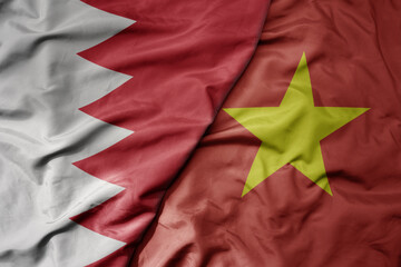 big waving realistic national colorful flag of bahrain and national flag of vietnam .