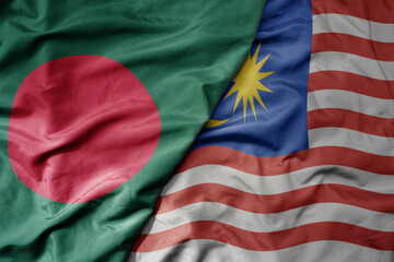 big waving realistic national colorful flag of bangladesh and national flag of malaysia .