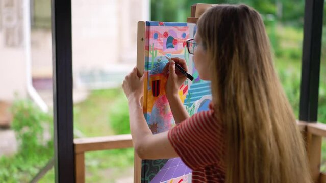 Woman painter paints a picture