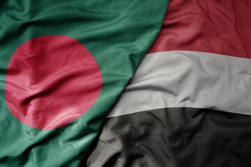 big waving realistic national colorful flag of bangladesh and national flag of yemen .