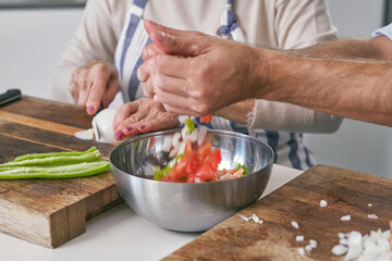 Unrecognizable man pouring ingredients into bowl