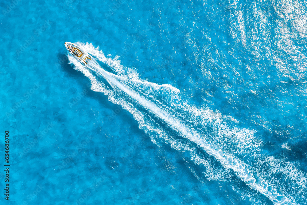 Wall mural aerial view on fast boat on azure mediterranean sea at sunny day. fast ship on the sea surface. seas