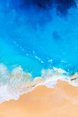 Waves and beach from a drone. Aerial landscape. Blue water background from drone. Summer seascape...