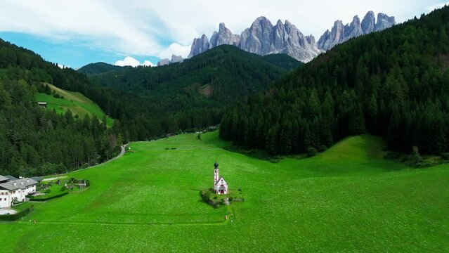 Church of St. Johann with The Dolomites mountains in the background in Val Di Funes valley, Trentino Alto Adige region, Italy, Europe.