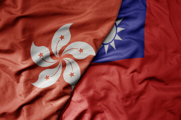 big waving realistic national colorful flag of hong kong and national flag of taiwan .