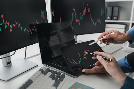 Two stock investors with stock market graph screen, stock fluctuation analysis, business man trading stocks for profit, stock market fluctuation graph screen, profit trading analysis.