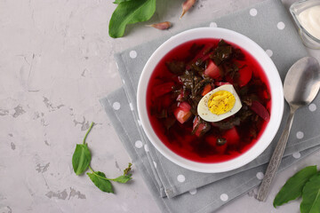 Beet soup with sorrel and egg in a white bowl, Closeup, View from above