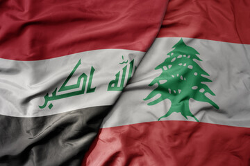 big waving realistic national colorful flag of iraq and national flag of lebanon .