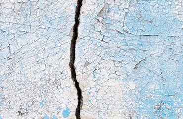 Big crack on cement wall background, old paint crack texture on concrete wall background