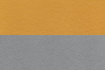 Fototapeta premium Texture of craft gray and dark yellow paper background, half two colors, macro. Vintage ocher cardboard.