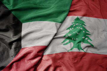 big waving realistic national colorful flag of kuwait and national flag of lebanon .