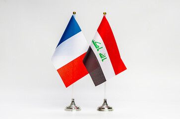 The national flags of France and Iraq on a light background.