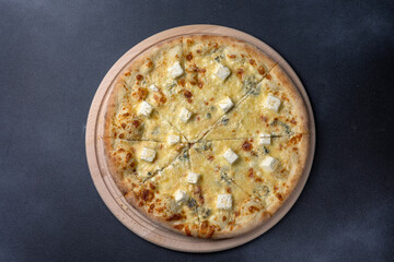 Italian cuisine. Delicious pizza on a dark background