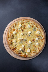 Italian cuisine. Delicious pizza on a dark background