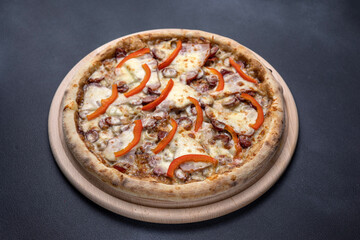 Italian cuisine. Delicious pizza on a dark background