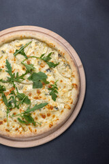Italian cuisine. Delicious pizza on a dark background