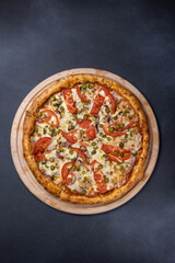 Italian cuisine. Delicious pizza on a dark background