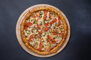 Italian cuisine. Delicious pizza on a dark background