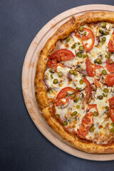 Italian cuisine. Delicious pizza on a dark background