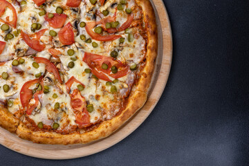 Italian cuisine. Delicious pizza on a dark background