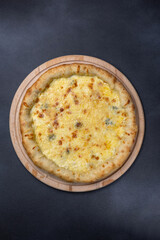 Italian cuisine. Delicious pizza on a dark background