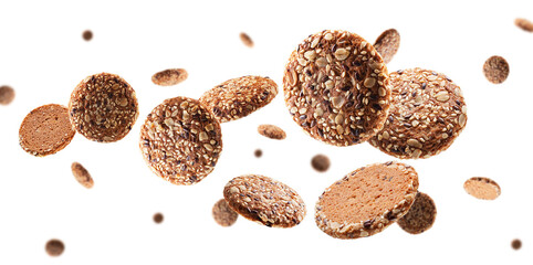 Oatmeal cookies sprinkled with seeds fly and levitate in space. Selective focus, isolated on white - obrazy, fototapety, plakaty