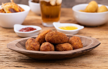 Typical brazilian meat filled snack on a plate with soda glass, ketchup and mustard