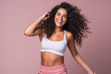 Obraz premium Pretty Latin woman in sports clothing doing some fun dance moves