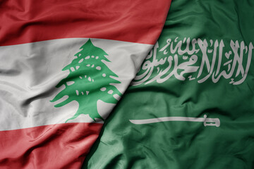 big waving realistic national colorful flag of lebanon and national flag of saudi arabia .