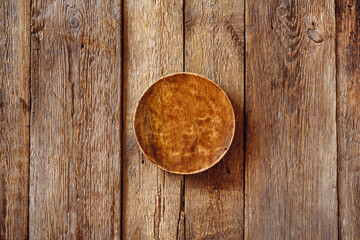 Wooden product presentation scene flat lay made with round plate on weathered wooden surface.