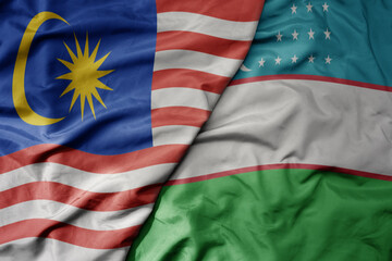 big waving realistic national colorful flag of malaysia and national flag of uzbekistan .