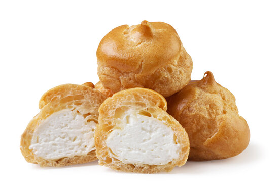 Pile of profiteroles and halves on a white background. Isolated
