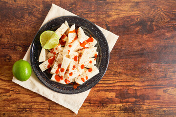 Mexican jicama fruit cutted with lime, chili and chamoy