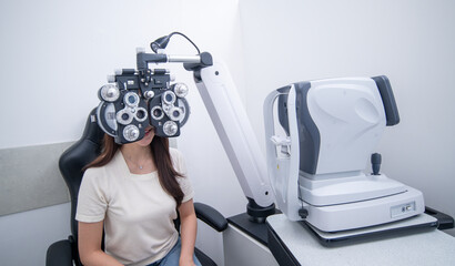 Woman optical shop customer doing eyesight measurement with optical phoropter check eye distance...