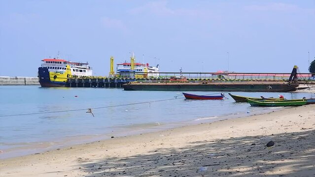 View Of The Beach With Several Fishing Boats And Ferries