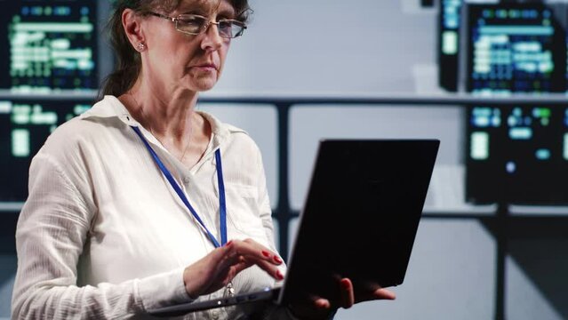 Senescent admin in high tech facility equipped to handle modern computing requirements, doing regular upgrades to blade servers, increasing processing power and storage capacity to prevent damages