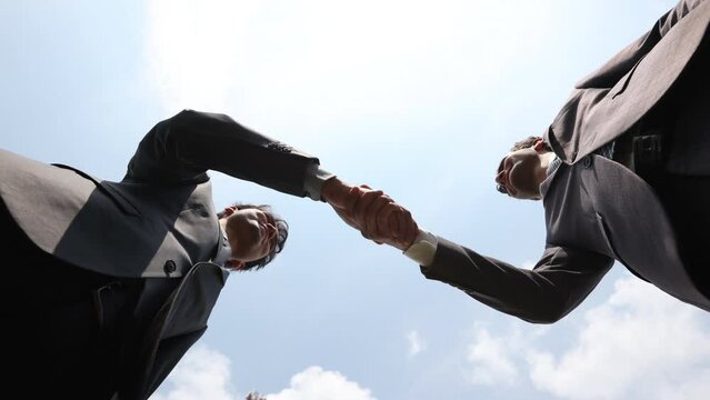handshake of business partners on the street. bottom view
