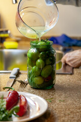 Pour brine into jar of green tomatoes....