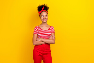 Photo of dreamy cute lady wear striped red t-shirt looking empty space arms folded isolated yellow color background
