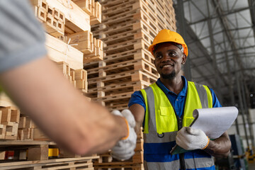 Technician shaking hand after checking and inspecting at cargo for stack item for shipping. males...