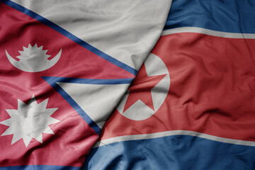 big waving realistic national colorful flag of nepal and national flag of north korea .