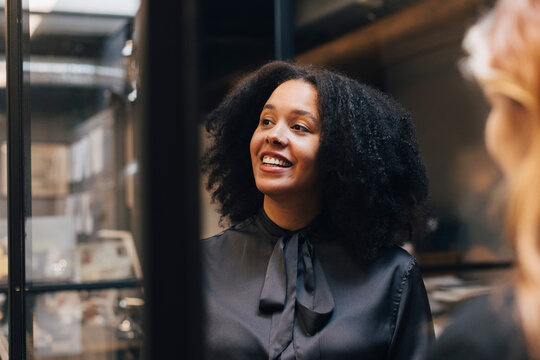 Happy businesswoman with Afro hairstyle in office