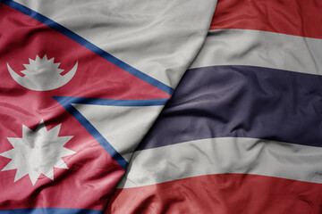 big waving realistic national colorful flag of nepal and national flag of thailand .