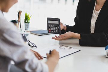 Businesswoman, real estate agent discussing the terms of the house purchase agreement contract...