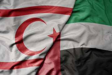 big waving realistic national colorful flag of northern cyprus and national flag of united arab emirates .