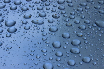 Large drops of water on a metal surface. Macro. Russia.