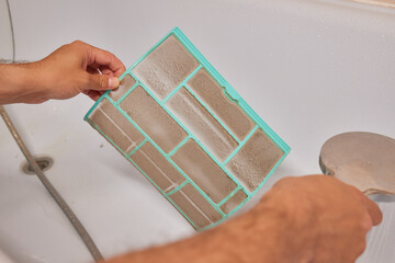 Washing air-conditioner filter with water