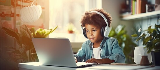 Biracial boy studying at home using technology for education