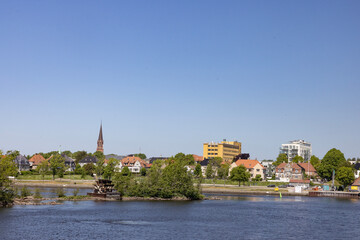 Obraz premium Happy walking in old Fredrikstad on a great warm summer day, with many old buildings, Norway 