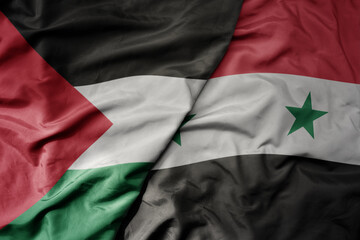big waving realistic national colorful flag of palestine and national flag of syria .